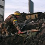 A Ukrainian serviceman holds a rocket-propelled grenade launcher at fighting positions outside Kharkiv